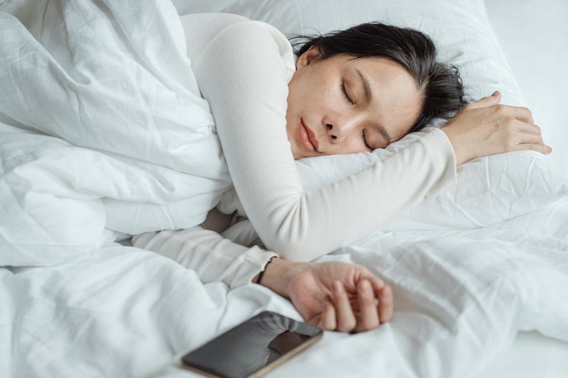 Sleep Habits - Woman Sleeping Near Smartphone